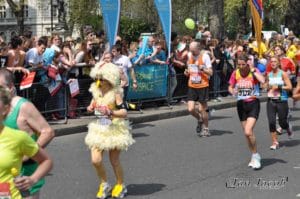 London-Marathon-2011-runner-cover-by-funny-chicken-costume-passing-Monument-to-the-RAF-on-Victoria-Embankment-London-UK